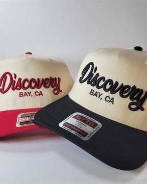 Cream Discovery Bay caps with red and black embroidered script